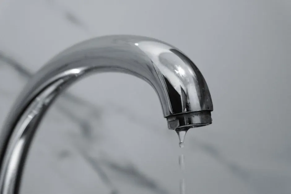 Modern chrome bathroom faucet with a thin stream of water