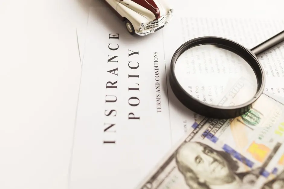 Insurance policy document with a magnifying glass on top