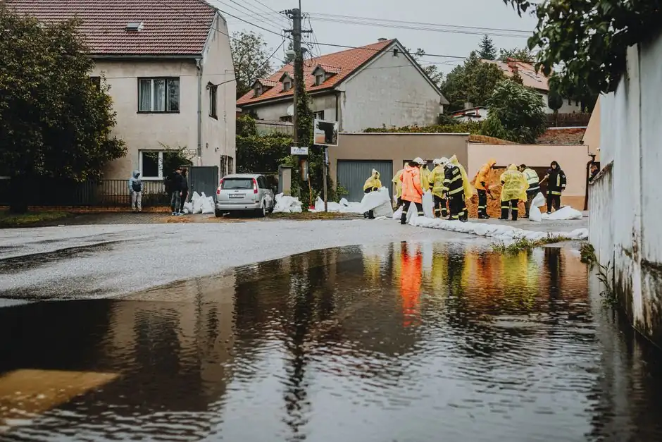 Emergency workers managing floodwater on a residential street